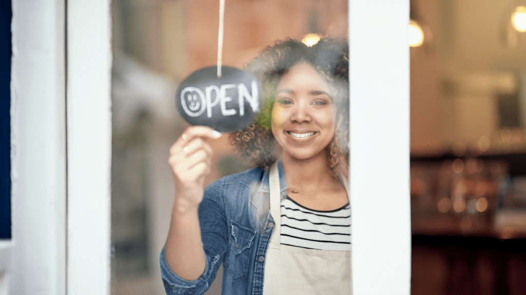 Woman business owner flipping sign to "open" 

Common Business Mistakes Business Owners Make