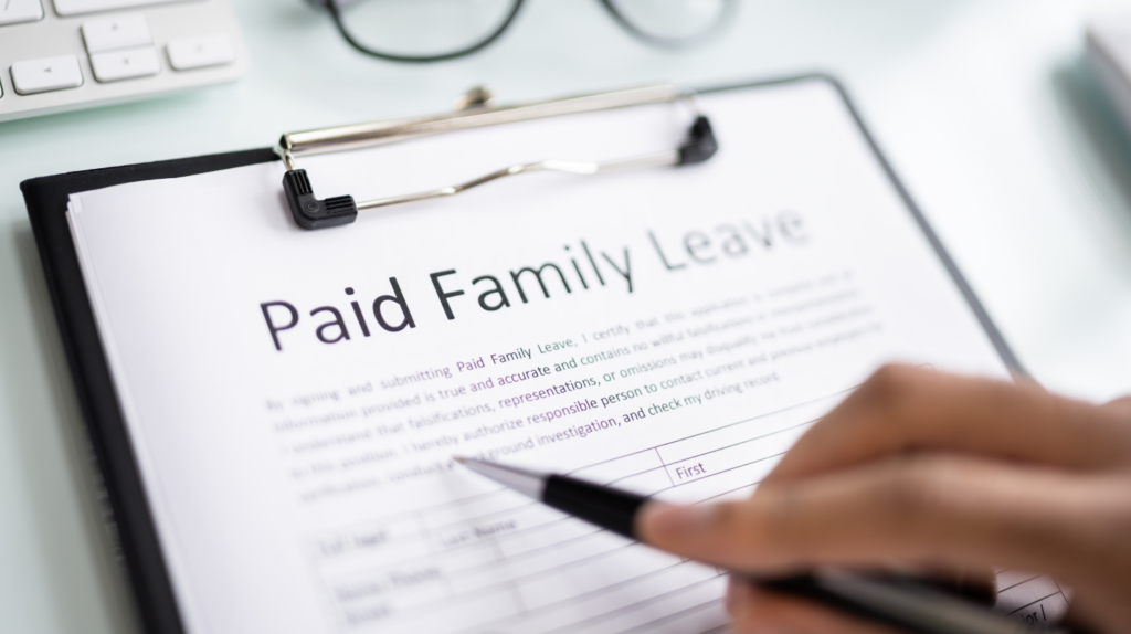 what to know about family and medical leave with an image of a document discussing paid leave on a clipboard